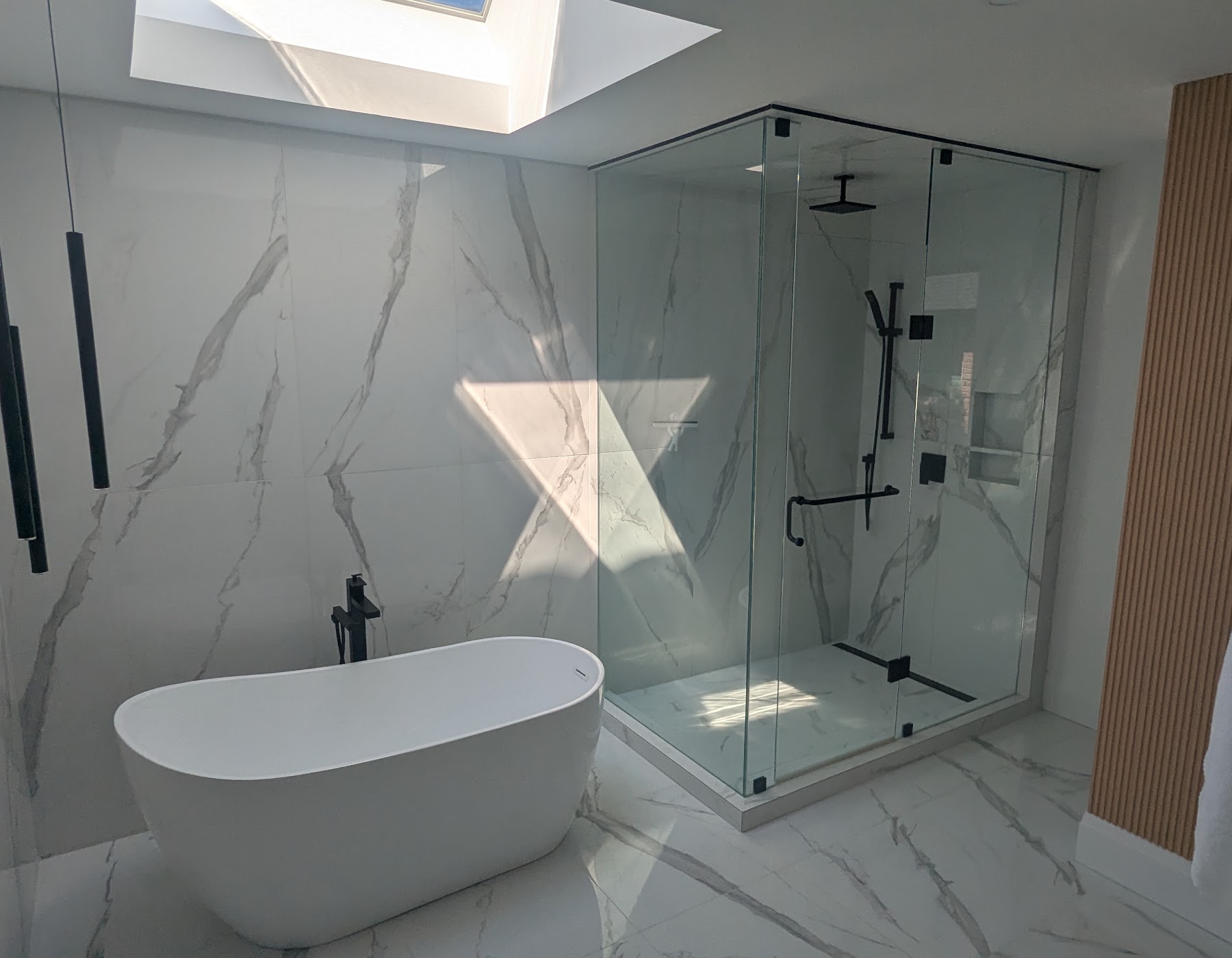 Finished luxury bathroom with freestanding tub and glass shower