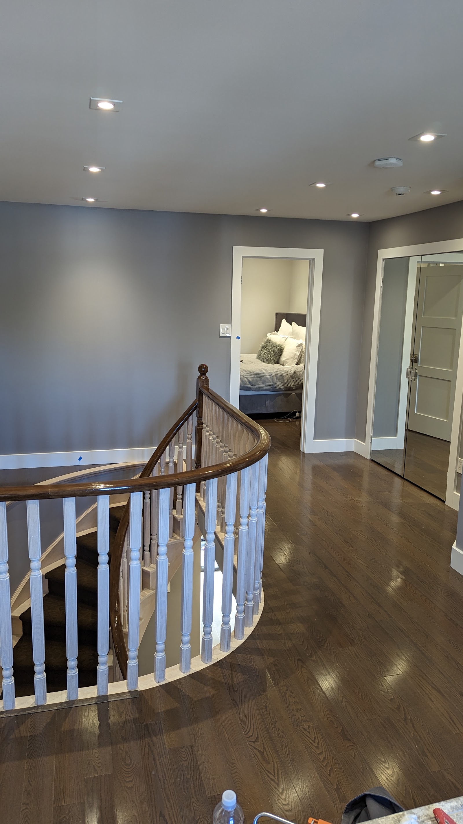 Finished stair railing, trim, lighting, and painted wall details